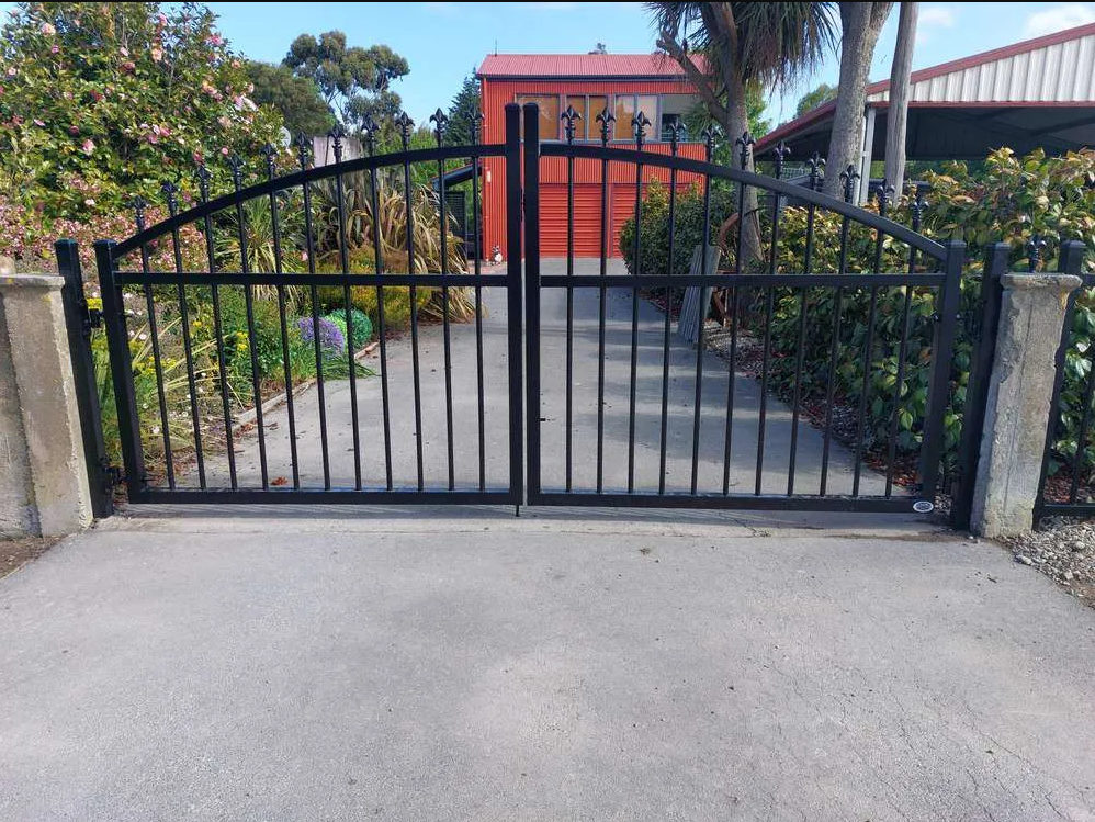 Residential metal gate being repaired with welding equipment