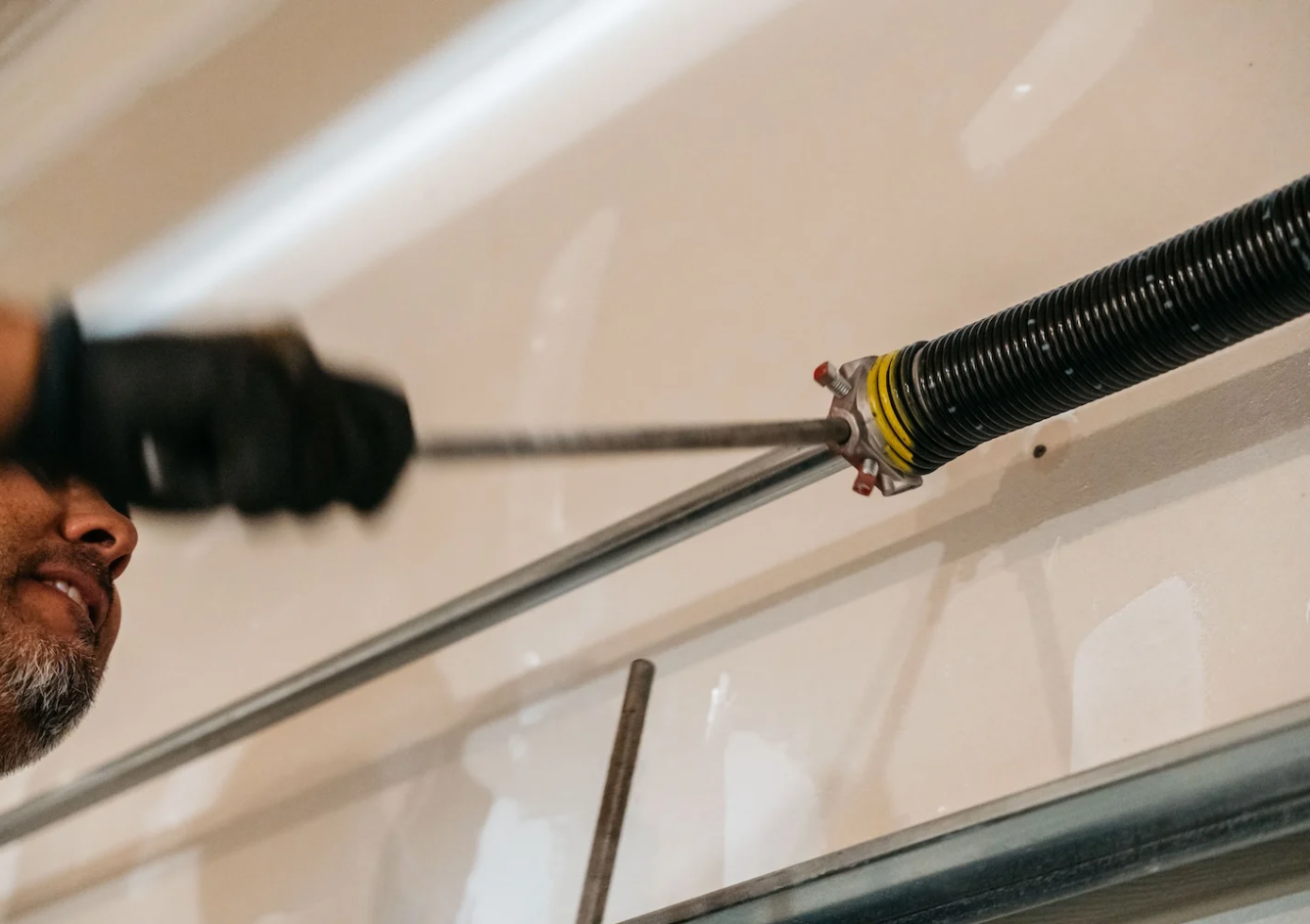 "Technician performing garage door spring repair in Sapphire Shores"