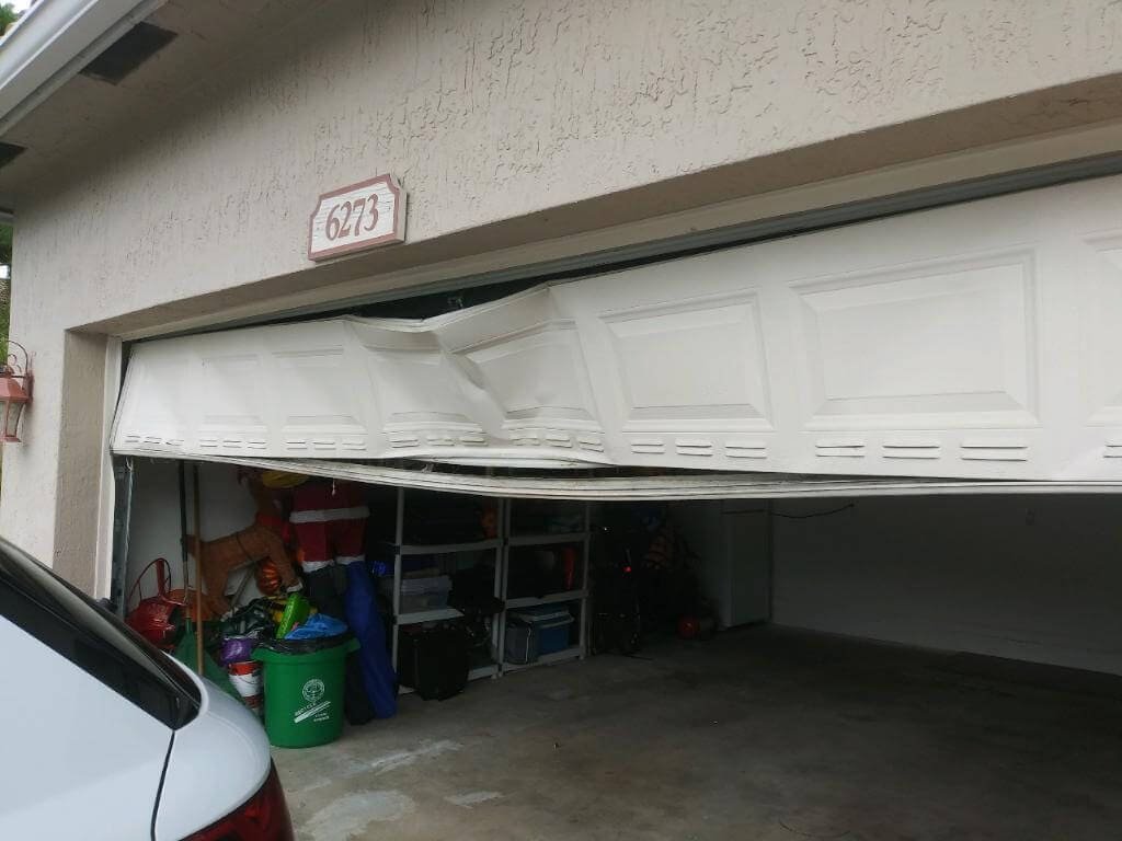 Replacement of an outdated garage door with a modern design featuring frosted glass panels"
