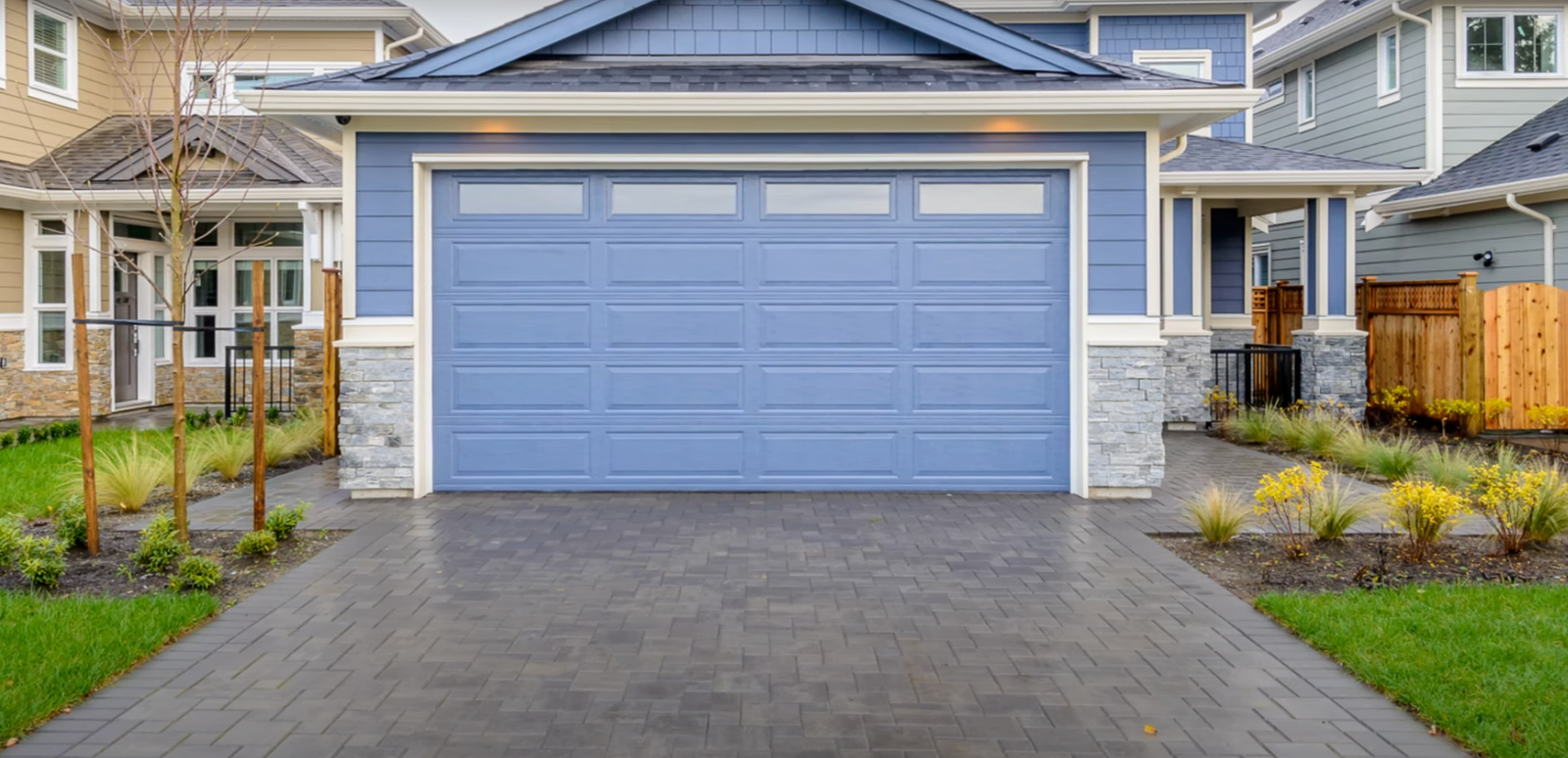 "Custom-designed garage door with modern detailing installed in a Sapphire Shores home, showcasing premium craftsmanship and durability for enhanced curb appeal."